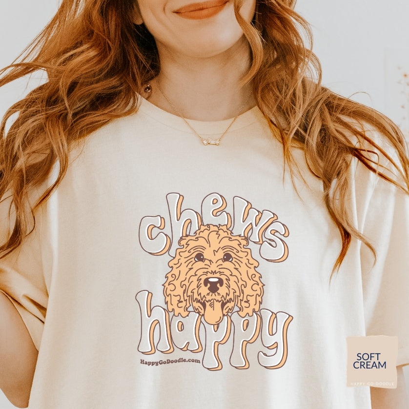 Goldendoodle t-shirt with Goldendoodle face and words "Chews Happy" in soft cream color