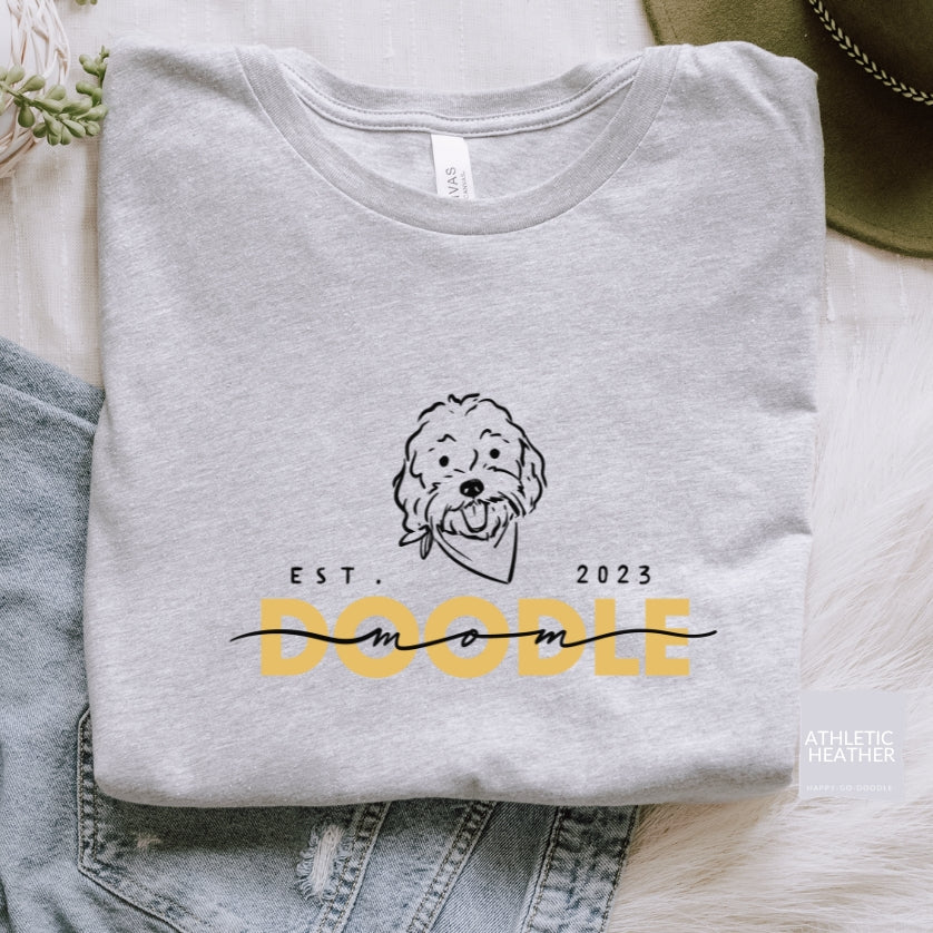 Goldendoodle Mom t-shirt with Goldendoodle face and words "Doodle Mom Est 2023" in athletic heather color