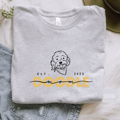 Goldendoodle Mom t-shirt with Goldendoodle face and words "Doodle Mom Est 2023" in athletic heather color