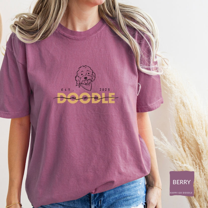 Goldendoodle Mom comfort colors t-shirt with Goldendoodle face and words "Doodle Mom Est 2023" in berry color