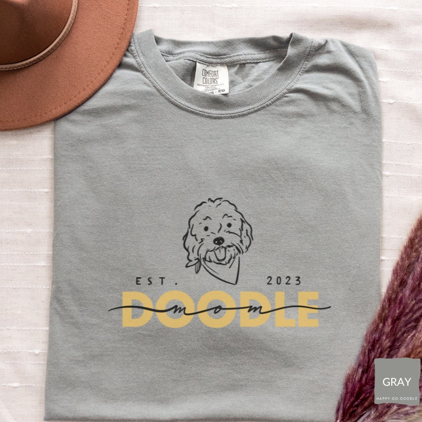Goldendoodle Mom comfort colors t-shirt with Goldendoodle face and words "Doodle Mom Est 2023" in gray  color