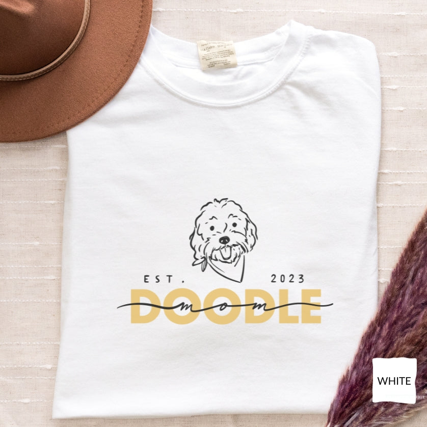Goldendoodle Mom comfort colors t-shirt with Goldendoodle face and words "Doodle Mom Est 2023" in white color