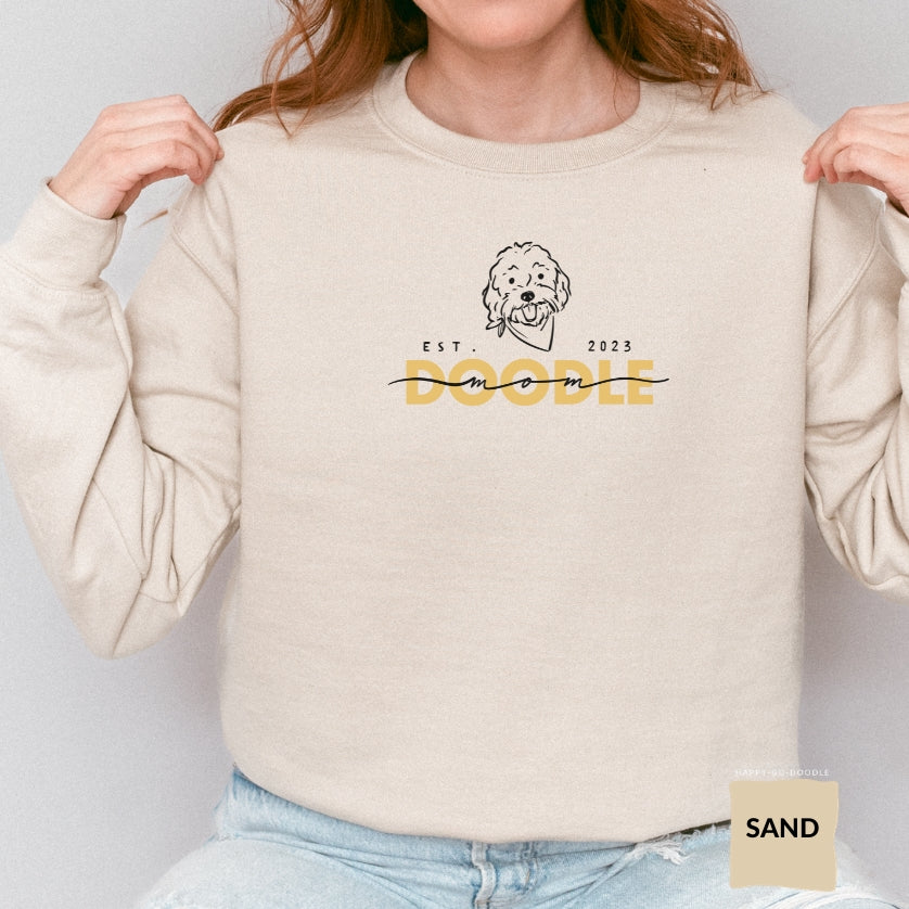 Goldendoodle Mom crew neck sweatshirt with Goldendoodle face and words "Doodle Mom Est 2023" in sand color