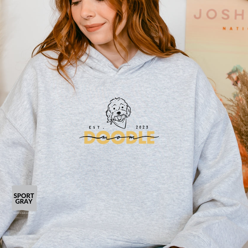 Goldendoodle Mom Hoodie with Goldendoodle face and words "Doodle Mom Est 2023" in Sport gray color