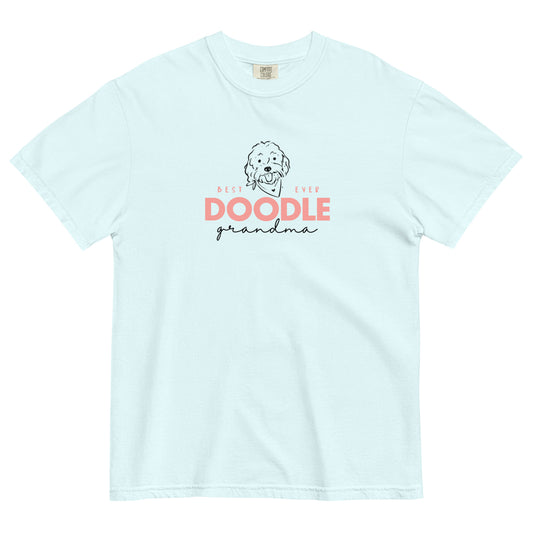 "Best EVER DOODLE Grandma" is the  message printed in soft pink with black accents and a cute Doodle dog's face  on the front of a soft blue T-Shirt. The tag inside the Goldendoodle Grandma shirt says Comfort Colors